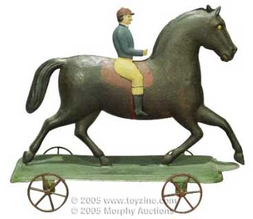 Early American wheeled tin horse on platform, with rider