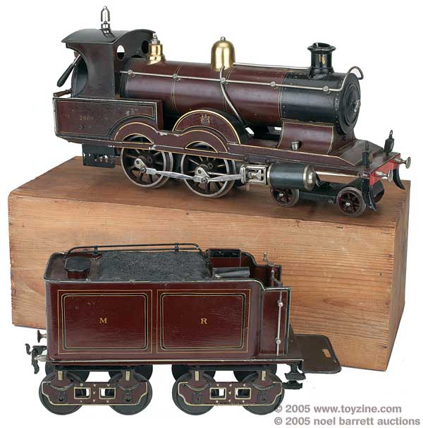 This English-style locomotive has its original wooden box. It is gauge III, and the loco and tender together are 32in long